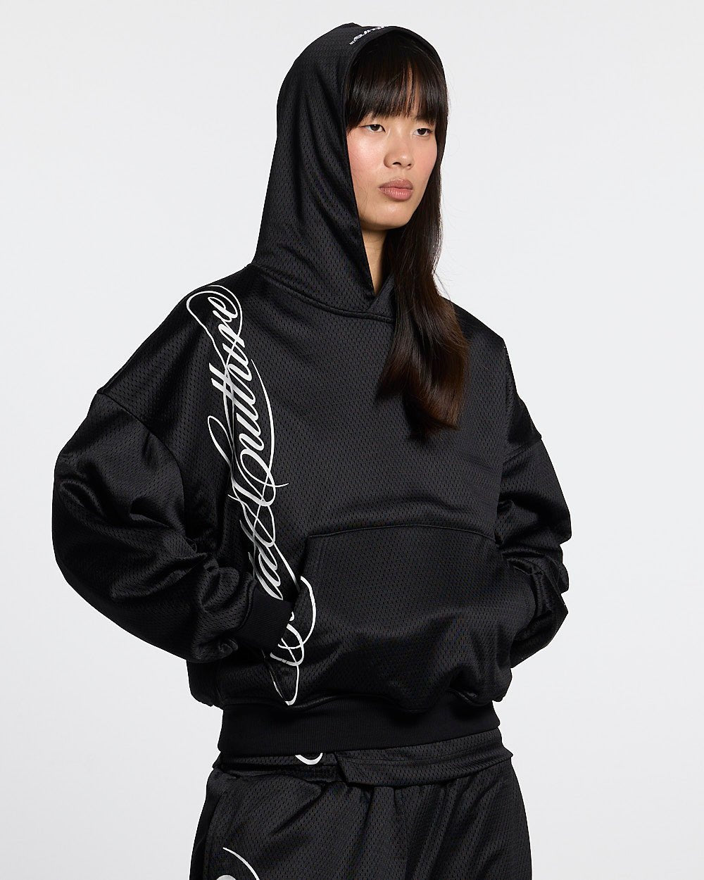 RIOT MESH HOODIE BLACK - black mesh hoodie, front view on female model - Cold Culture #woman
