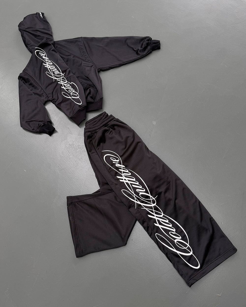 RIOT MESH HOODIE BLACK - black mesh hoodie, flat lay with matching pieces - Cold Culture