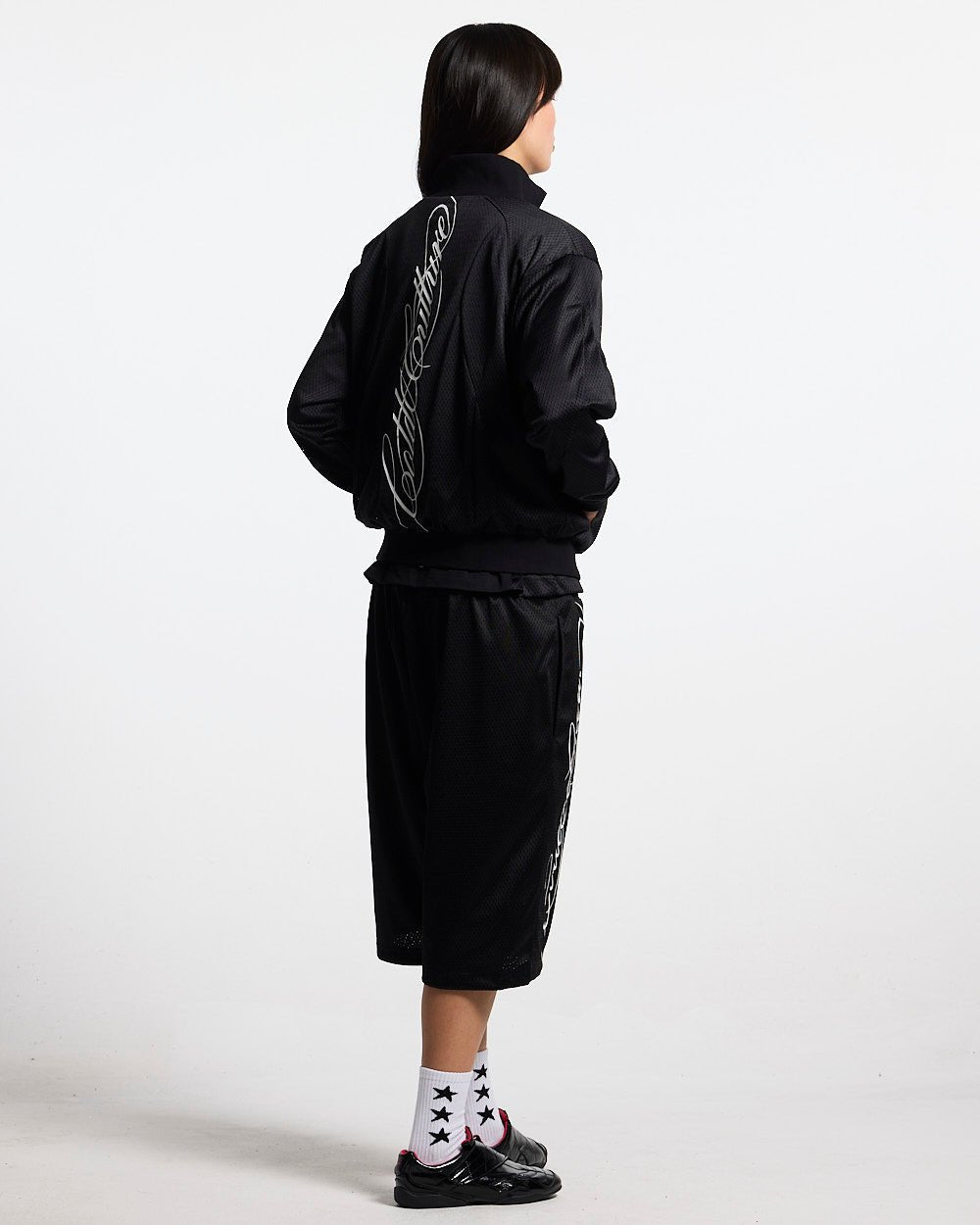 RIOT MESH JACKET BLACK - black mesh track jacket, back view on female model - Cold Culture #woman