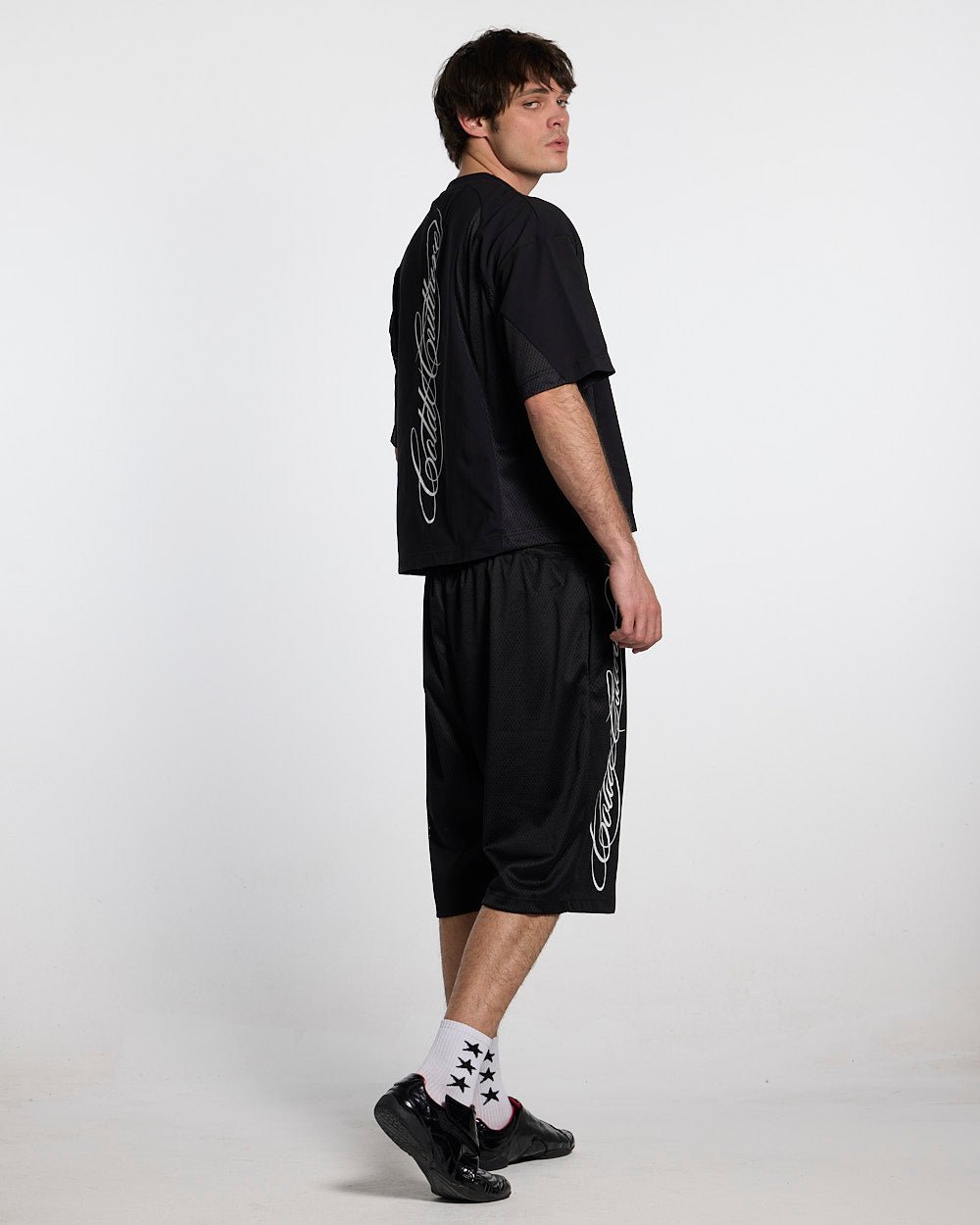 RIOT MESH SHORT BLACK - black mesh shorts, back view on male model - Cold Culture #man