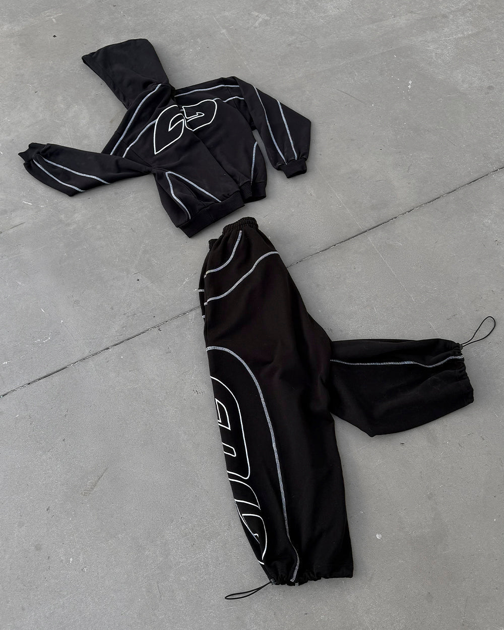 ROLLER SWEATPANTS BLACK - black contrast stitch sweatpants, flat lay with matching pieces - Cold Culture