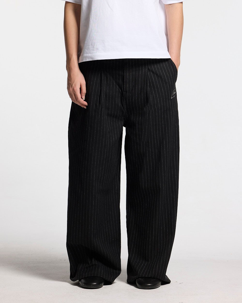 SEAM EFFECT LINE PANTS BLACK - black pinstripe pants, front view on female model - Cold Culture #woman