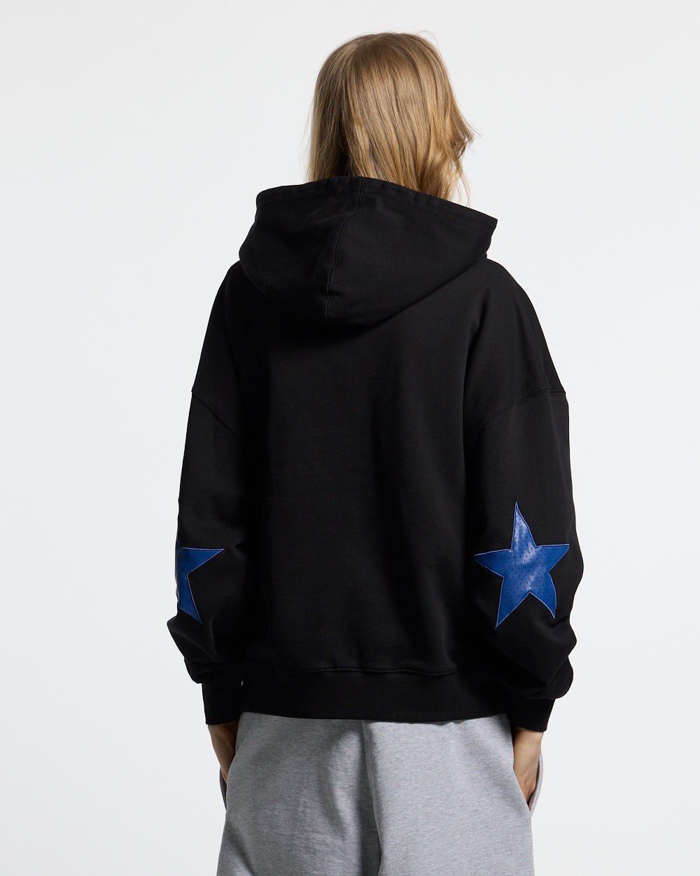 STAR CURVED ZIP HOODIE BLACK - black zip-up hoodie, back view on female model - Cold Culture #woman