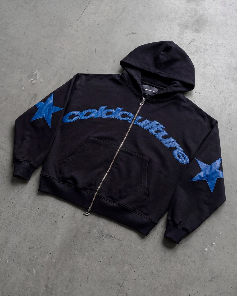 STAR CURVED ZIP HOODIE BLACK - black zip-up hoodie, flat lay - Cold Culture
