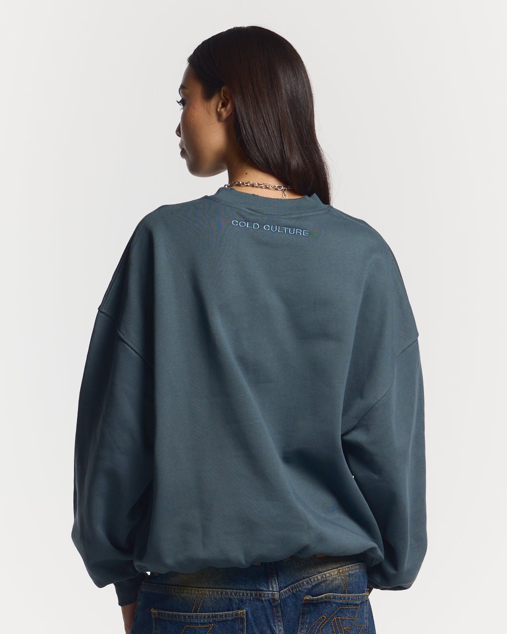STARS CREWNECK SLATE BLUE - slate blue oversized crewneck sweatshirt, back view on female model - Cold Culture #woman