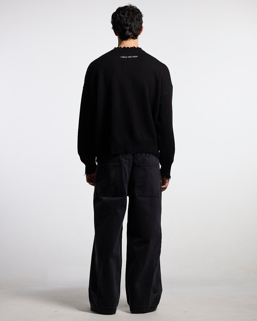 STARS KNIT BLACK - black distressed knit sweater, back view on male model - Cold Culture #man