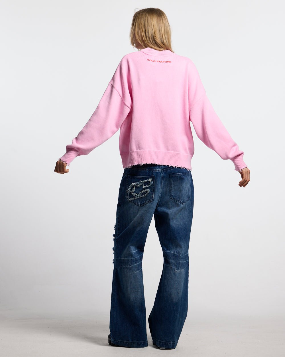 STARS KNIT PINK - pink star print knit sweater, back view on female model - Cold Culture #woman