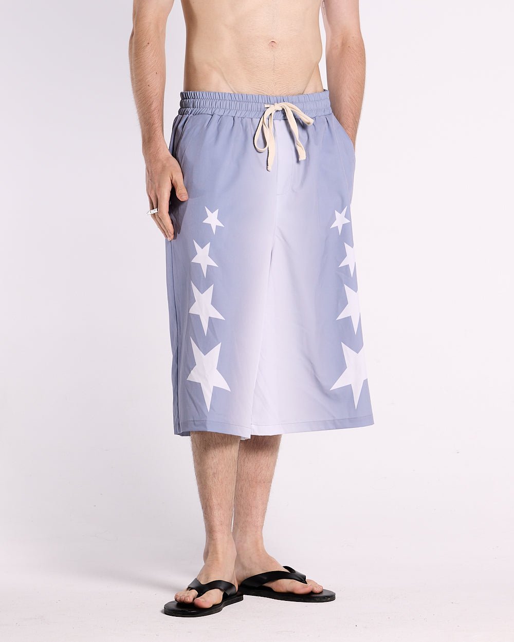 STARS WIDE SWIM SHORTS LILAC - lilac star print swim shorts, front view on male model - Cold Culture