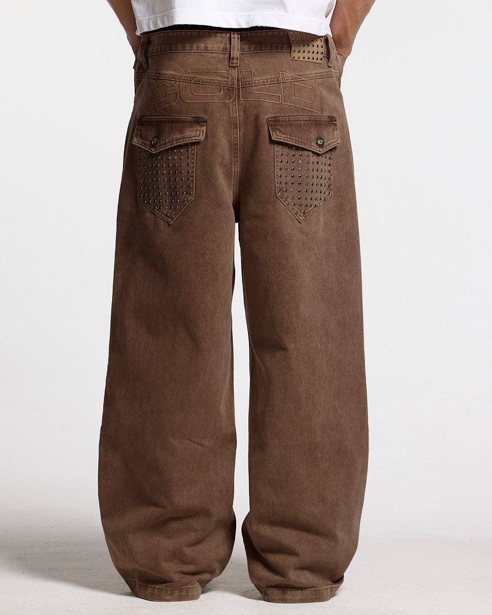 STUDS PANTS BROWN DENIM - brown studded denim pants, front view on male model - Cold Culture