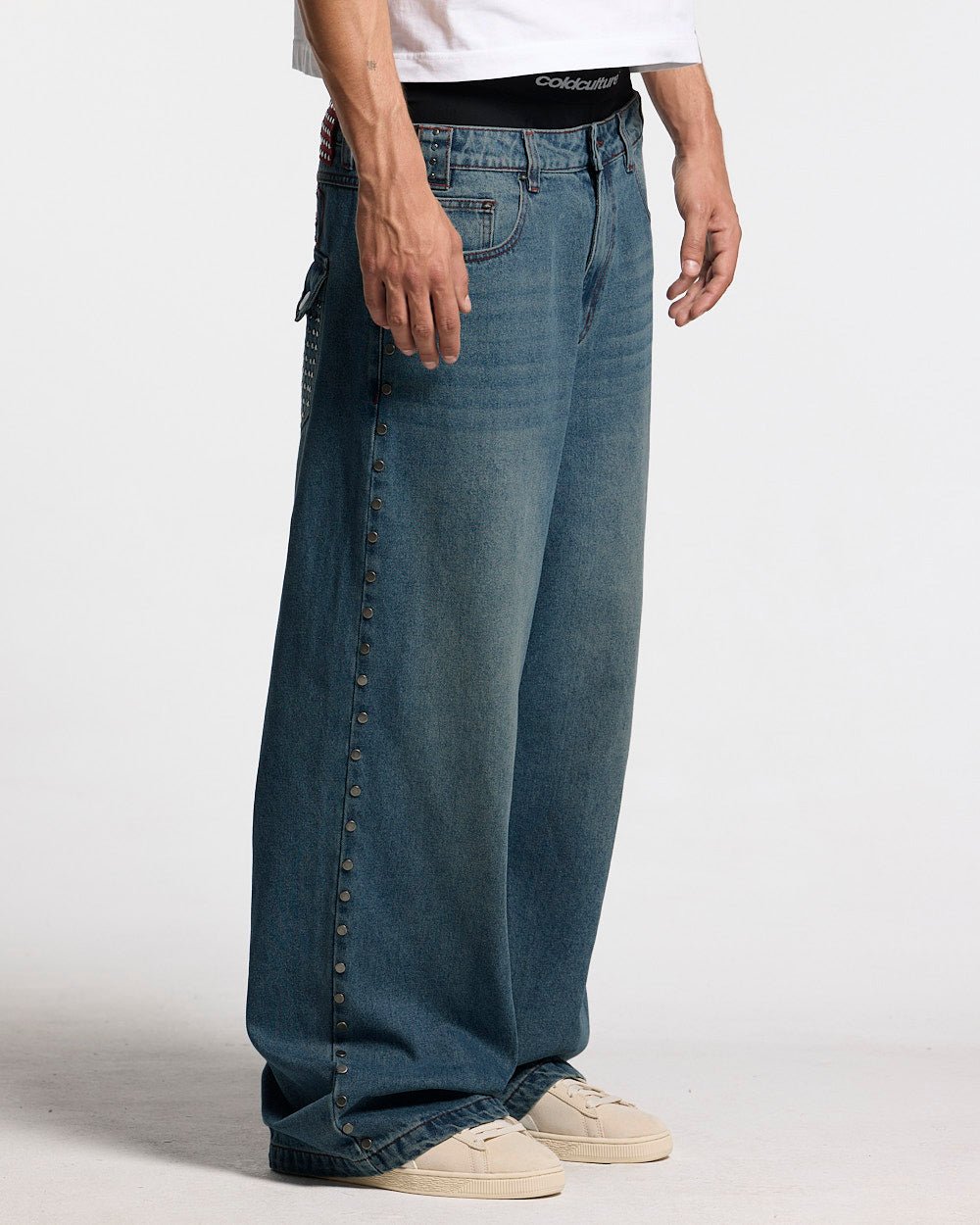 STUDS PANTS LIGHT BLUE DENIM - washed blue studded denim pants, side view - Cold Culture