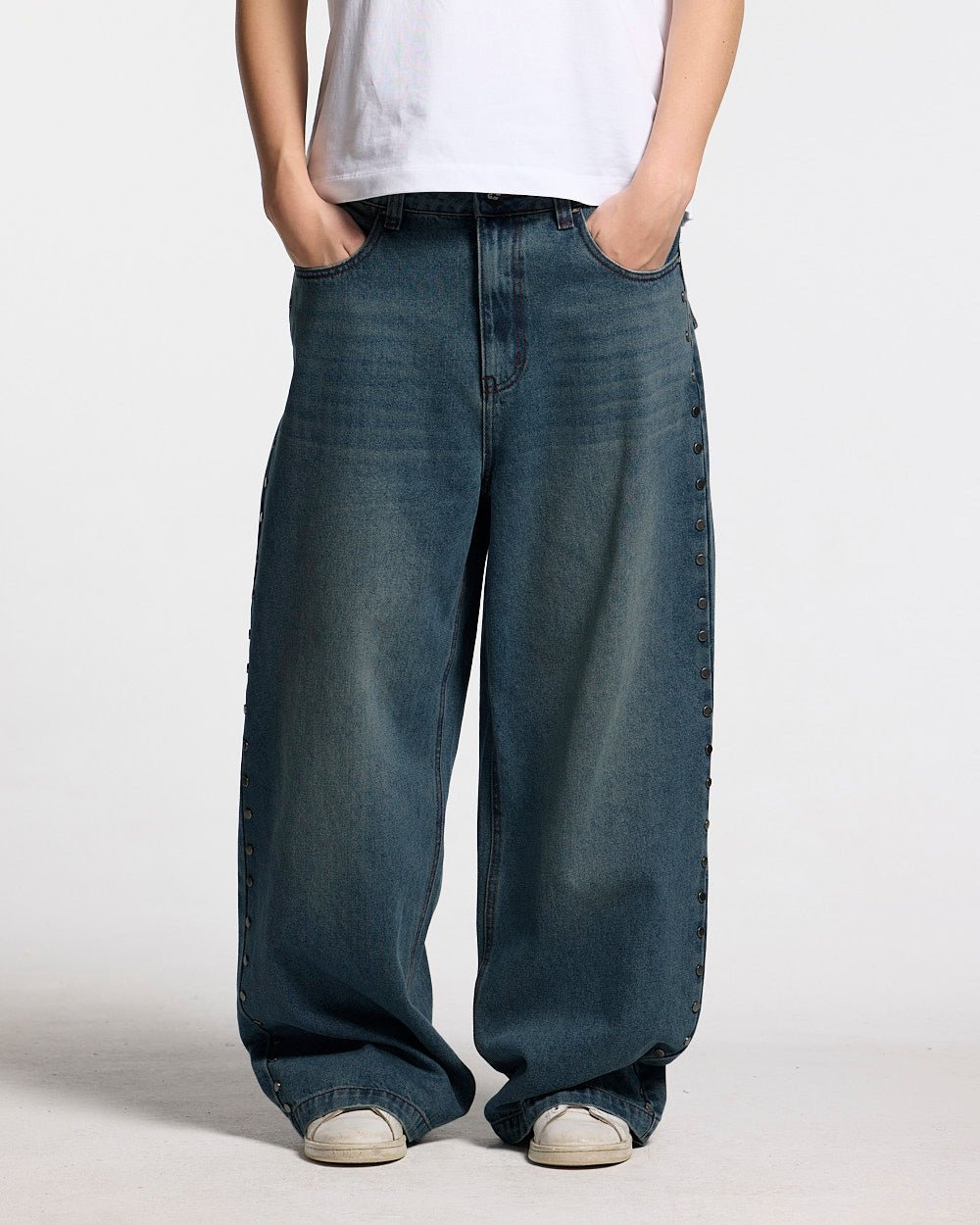 STUDS PANTS LIGHT BLUE DENIM - washed blue studded denim pants, front view on female model - Cold Culture #woman