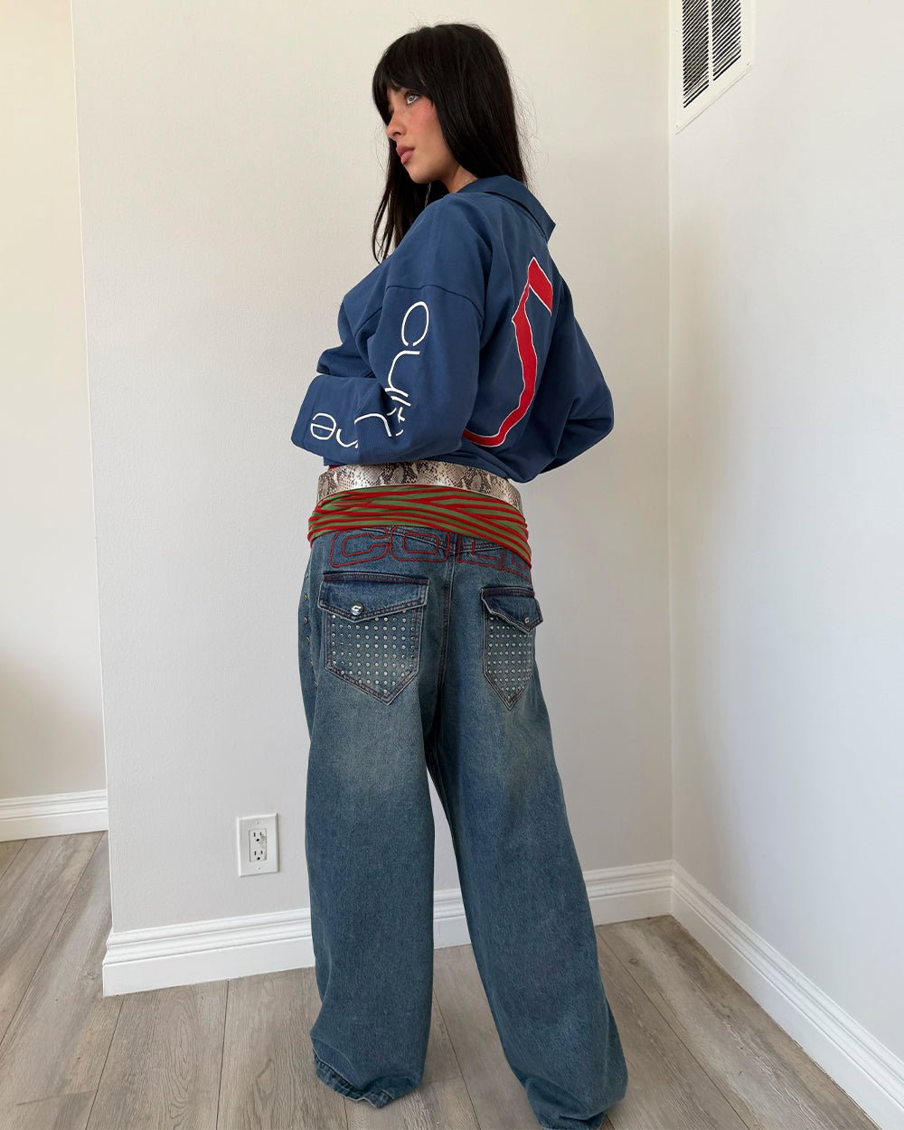 STUDS PANTS LIGHT BLUE DENIM - washed blue studded denim pants, back view on female model - Cold Culture #woman