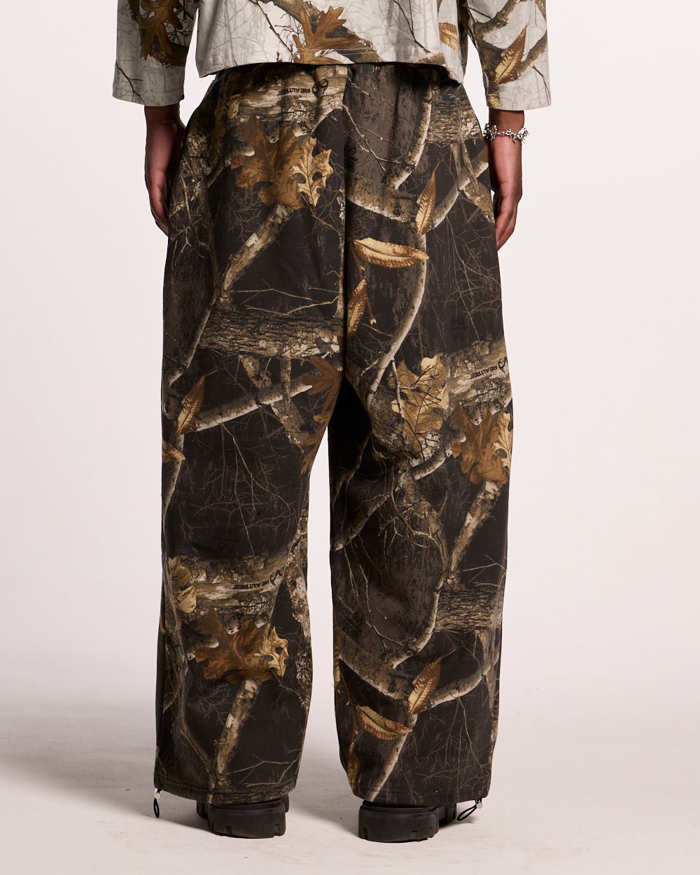 SWEATPANTS REALTREE BLACK - black camo sweatpants, back view on male model - Cold Culture