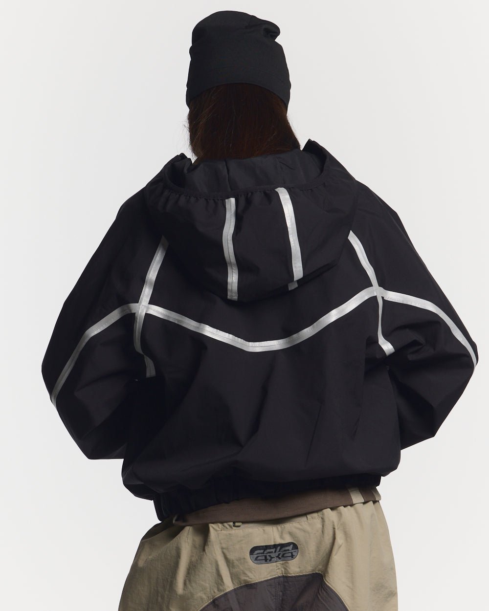 TAKE OFF LIGHTWEIGHT JACKET BLACK - black reflective trim jacket, back view on female model - Cold Culture #woman
