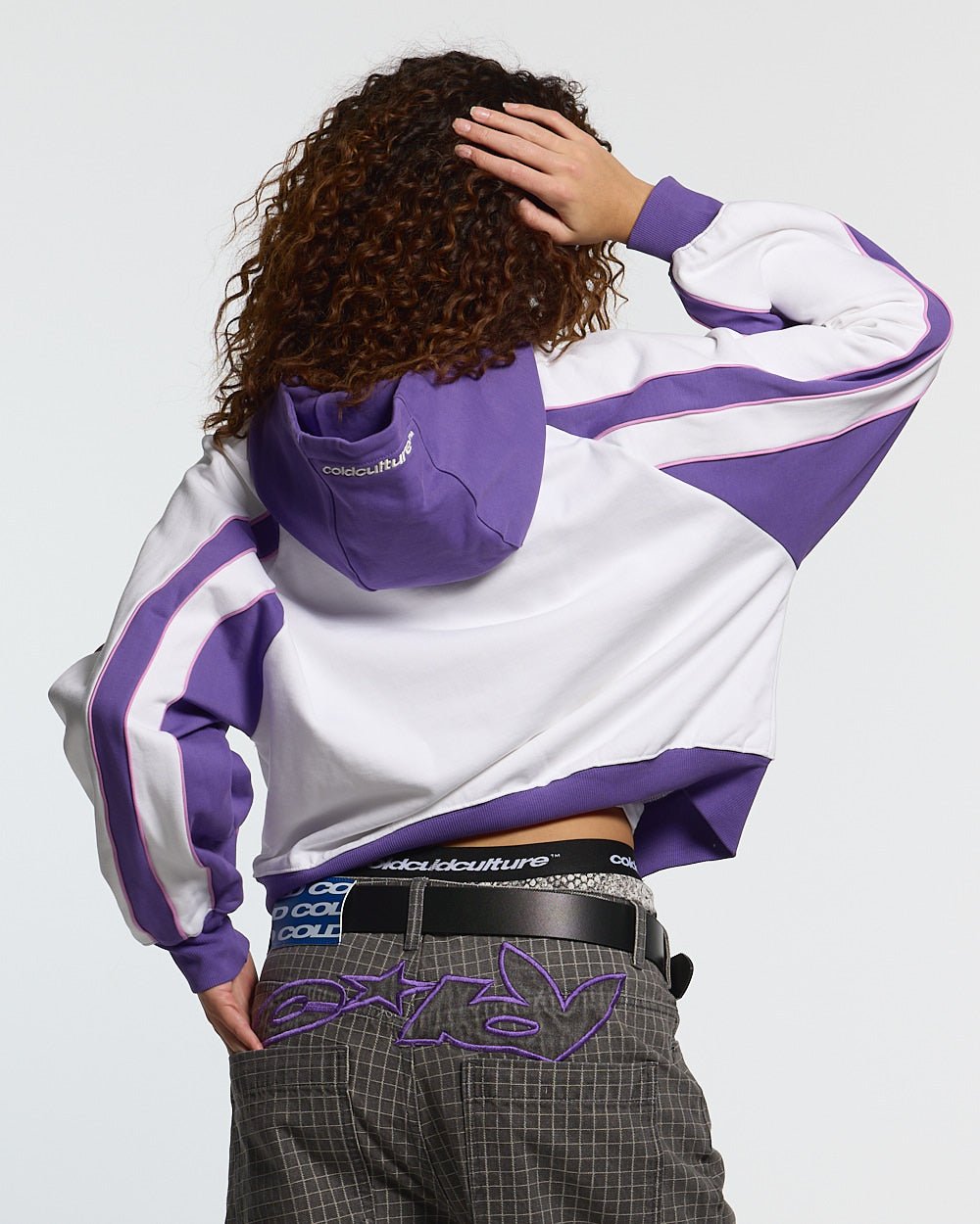 TEASE ME ZIP HOODIE WHITE & PURPLE - white and purple zip-up hoodie, back view on female model - Cold Culture #woman