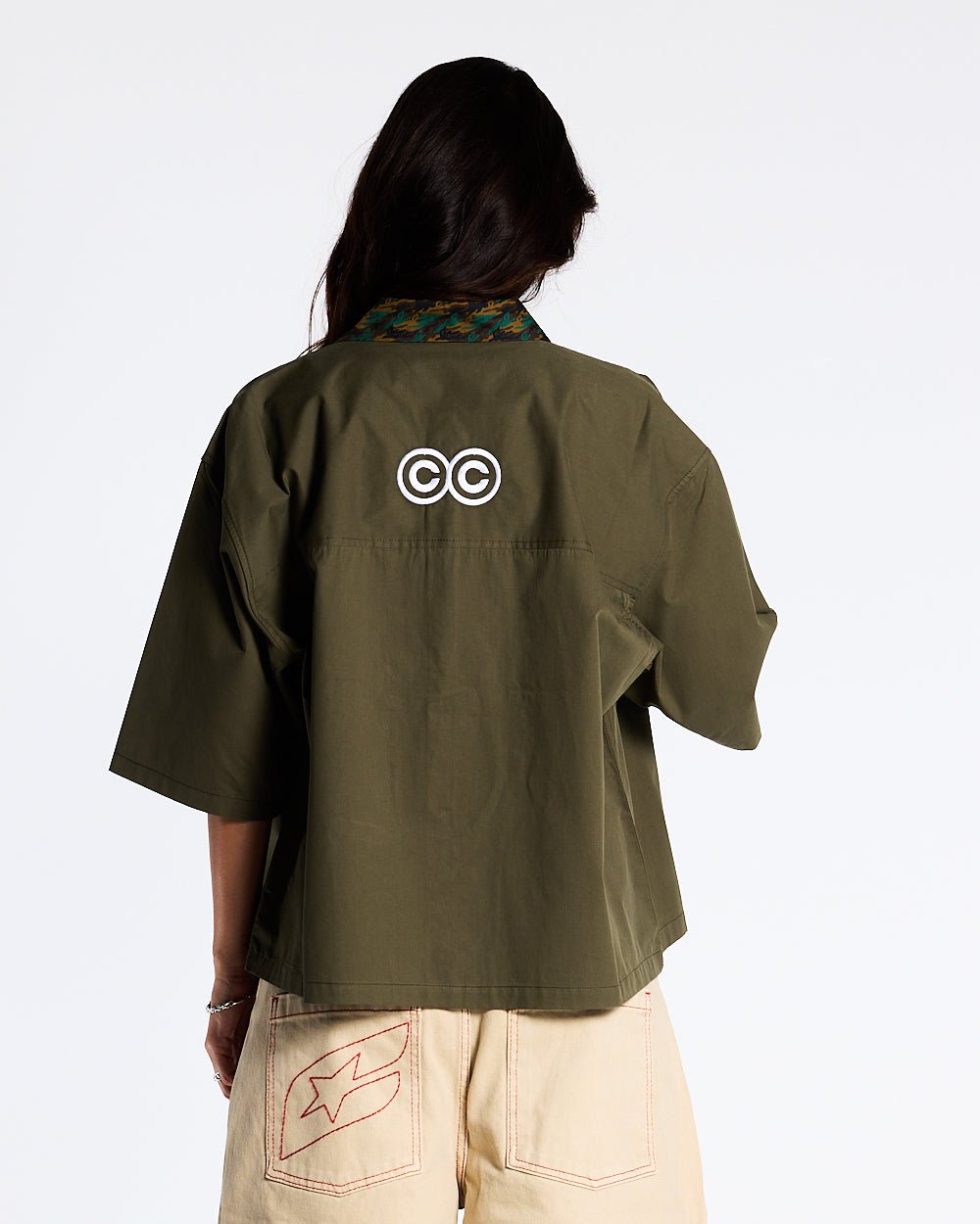 TERRA SHIRT CAPER GREEN - olive green short sleeve shirt, back view on female model - Cold Culture #woman