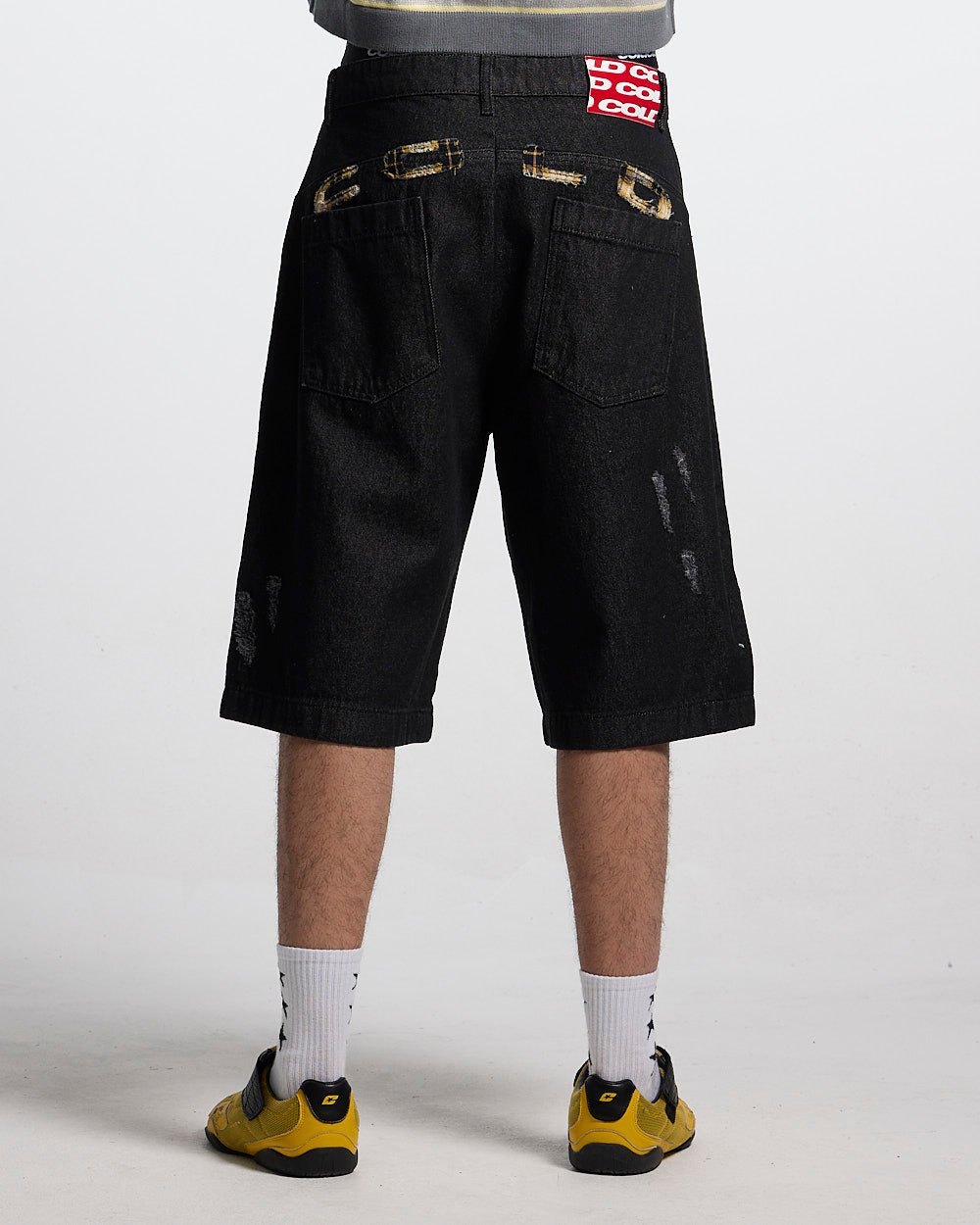 TOXIC SHORTS BLACK DENIM - black distressed denim shorts, back view on male model - Cold Culture