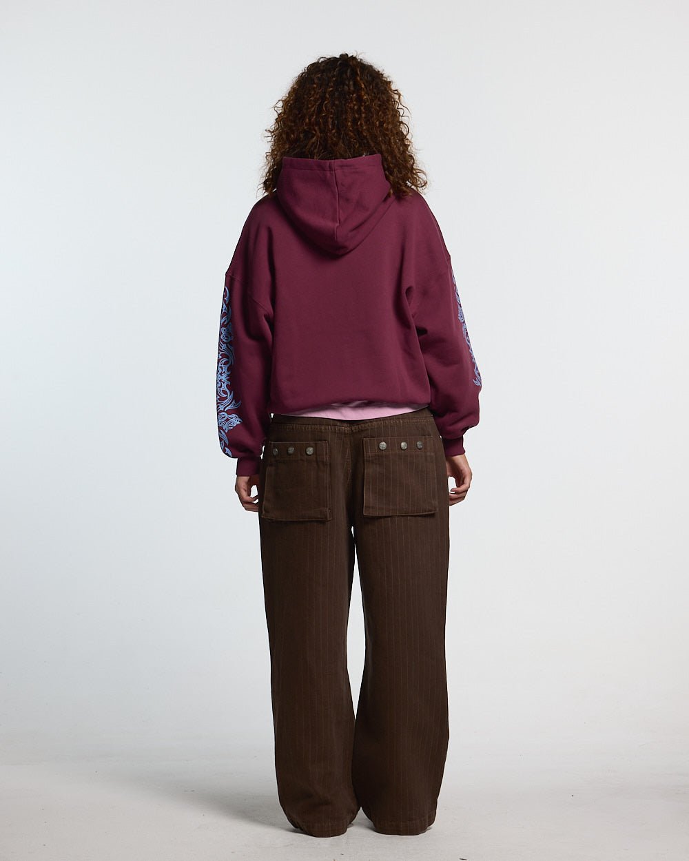 TRIBAL HOODIE BURGUNDY - burgundy tribal print hoodie, back view on female model - Cold Culture #woman