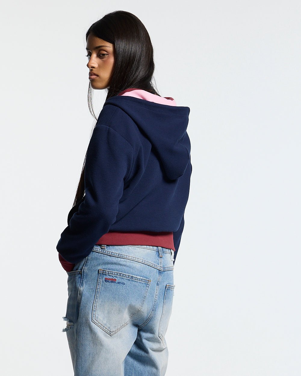 UNTRUE WAFFLE REVERSIBLE ZIP HOODIE PINK - pink striped reversible zip-up hoodie, back view on female model - Cold Culture #woman