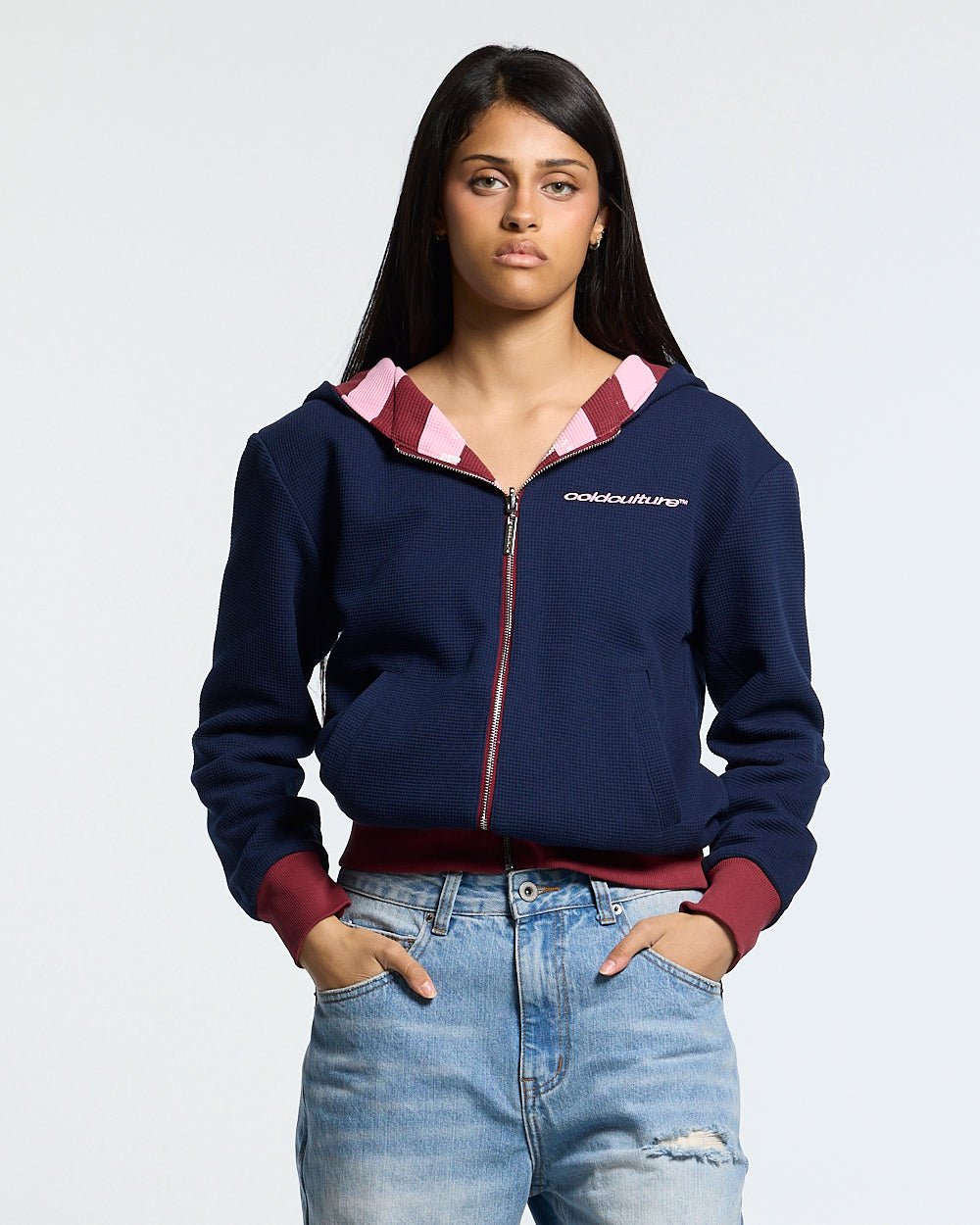 UNTRUE WAFFLE REVERSIBLE ZIP HOODIE PINK - pink striped reversible zip-up hoodie, front view on female model - Cold Culture #woman
