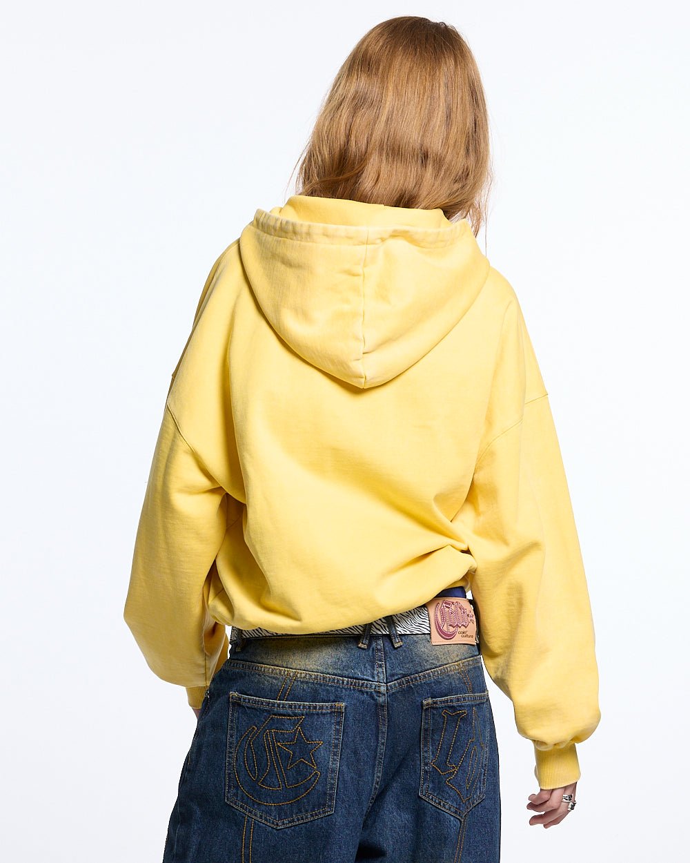 WALKER ZIP HOODIE YELLOW - yellow zip-up hoodie with patches, back view on female model - Cold Culture #woman