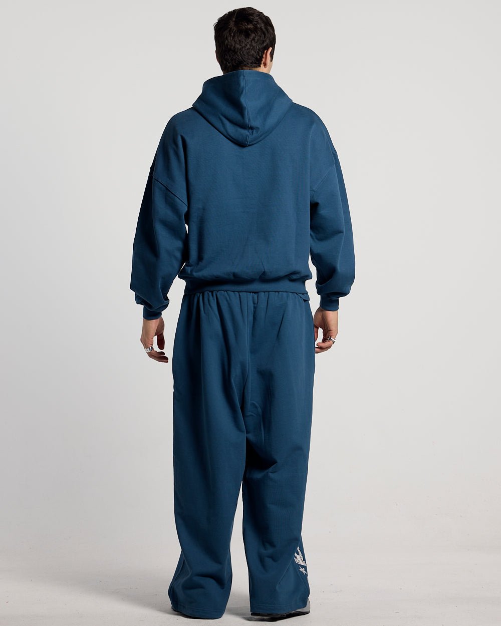 WILD SNAKE SWEATPANTS NAVY BLUE - navy blue baggy sweatpants, back view on male model - Cold Culture