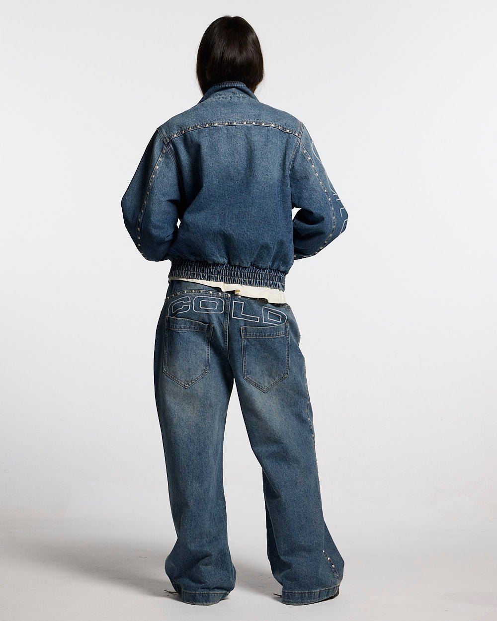 2010 DENIM JACKET BLUE DENIM - blue studded denim jacket, back view on female model - Cold Culture #woman