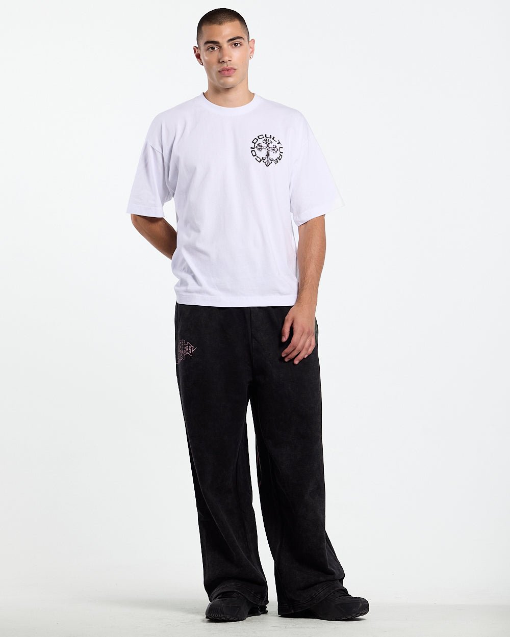 55 SWEATPANTS BLACK - washed black graphic sweatpants, front view on male model - Cold Culture #man