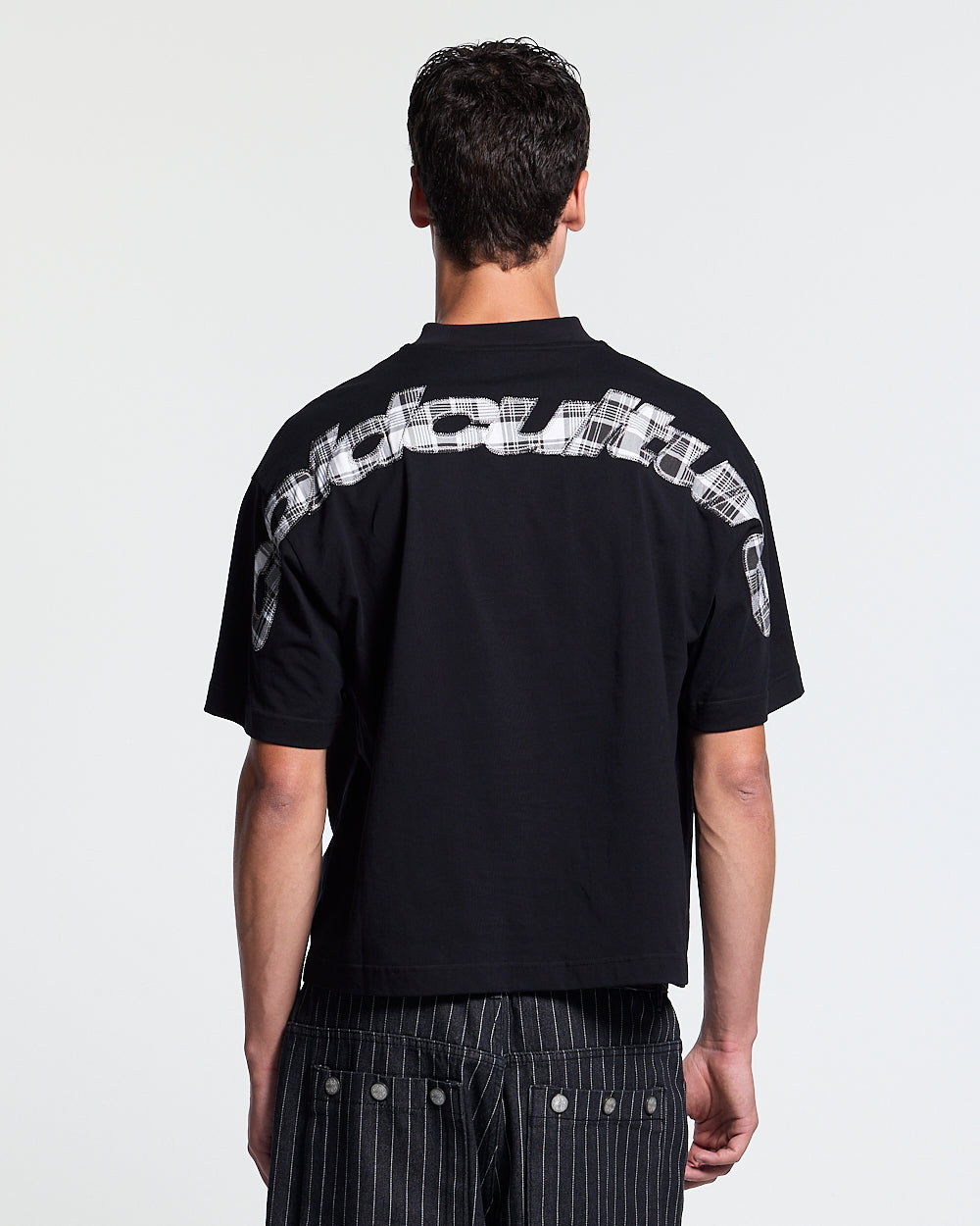 TARTAN DISTRESS CURVED TEE BLACK - black distressed print tee, back view on male model - Cold Culture #man