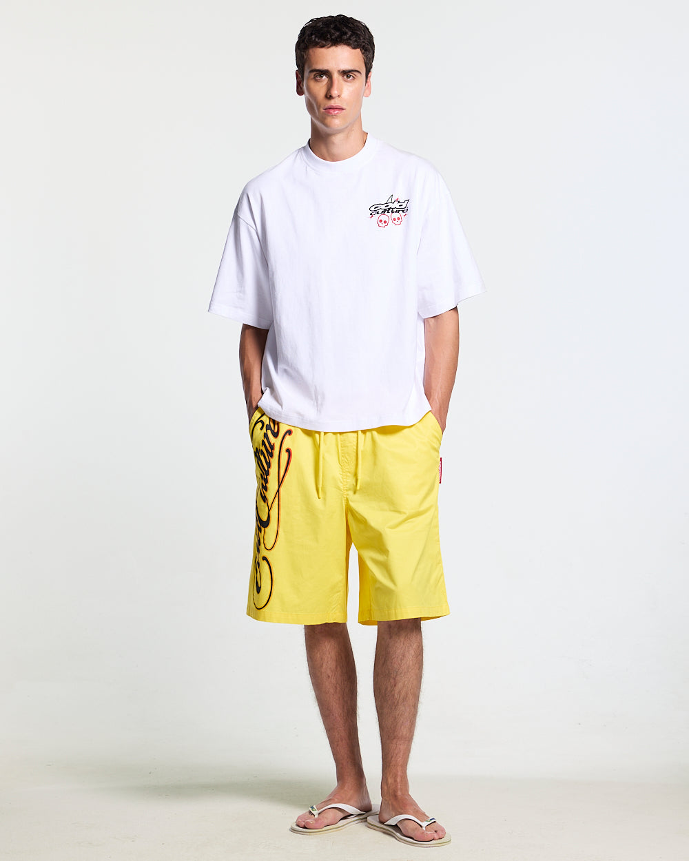 SCRIPT SWIMSHORTS YELLOW - yellow script print swim shorts, front view on male model - Cold Culture #man