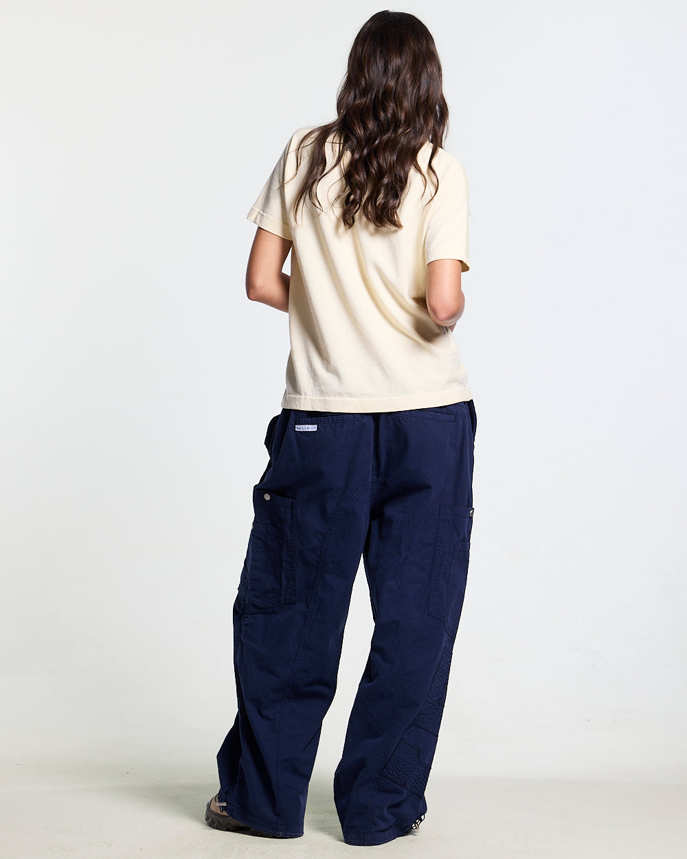 SOLID CARGO PANTS NAVY - navy cargo pants, back view on female model - Cold Culture #woman
