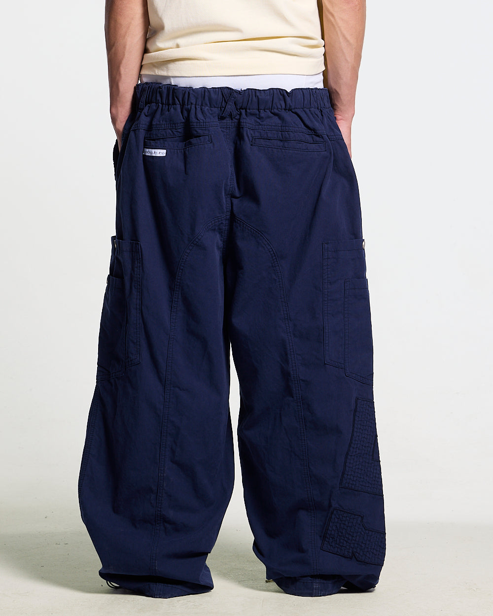 SOLID CARGO PANTS NAVY - navy cargo pants, back view on male model - Cold Culture