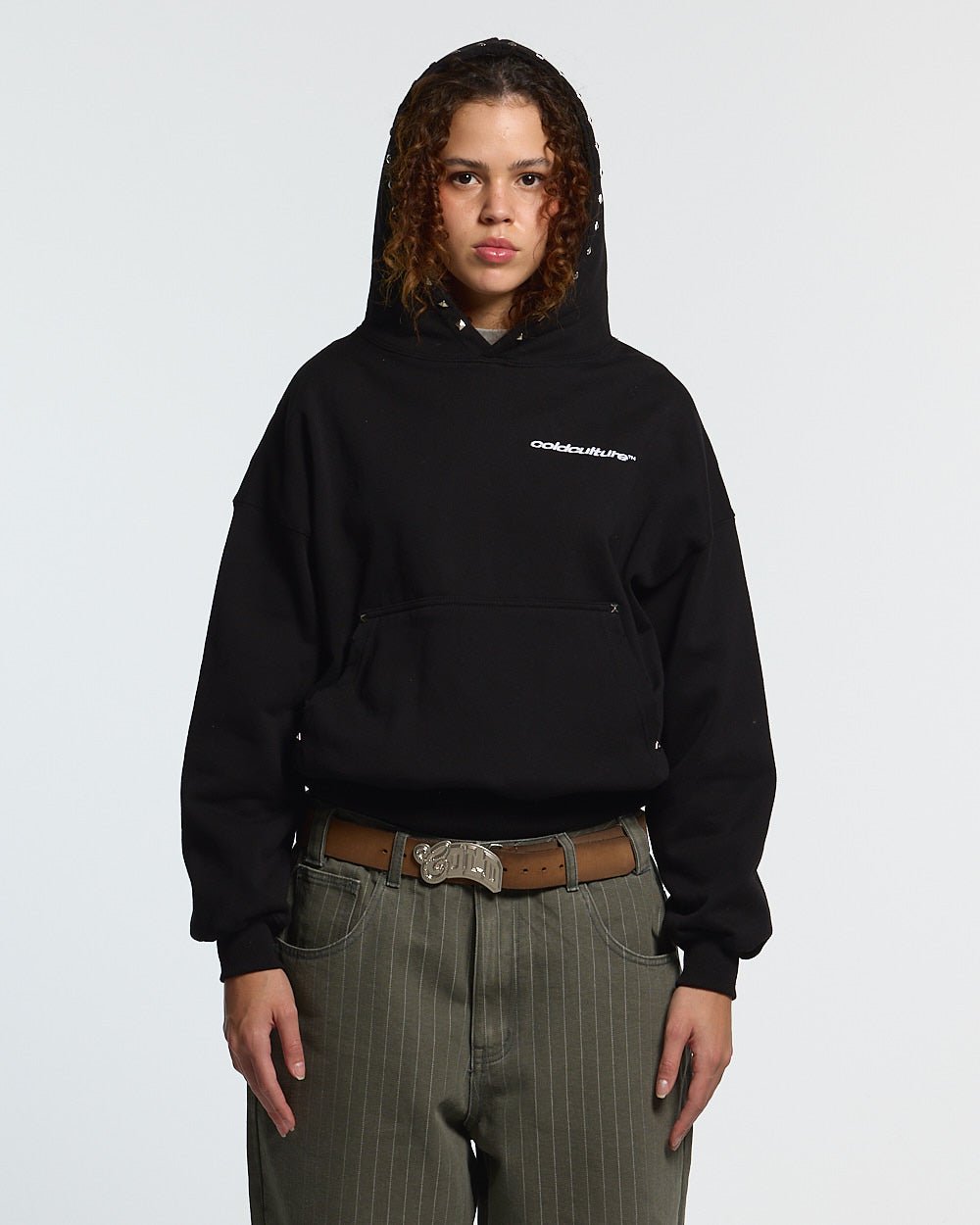 BADGES HOODIE BLACK - black studded hoodie, front view on female model - Cold Culture #woman