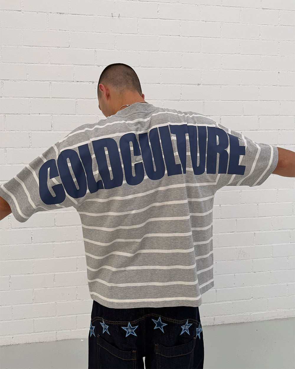 BAY STRIPE TEE GREY - grey striped tee, back view on male model - Cold Culture