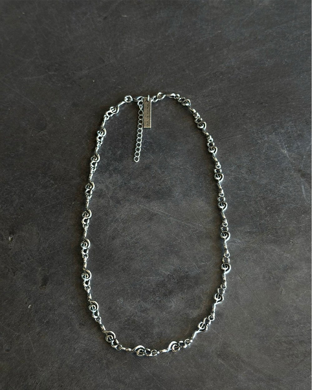 BEAT IT NECKLACE SILVER - silver treble clef chain necklace, flat lay - Cold Culture