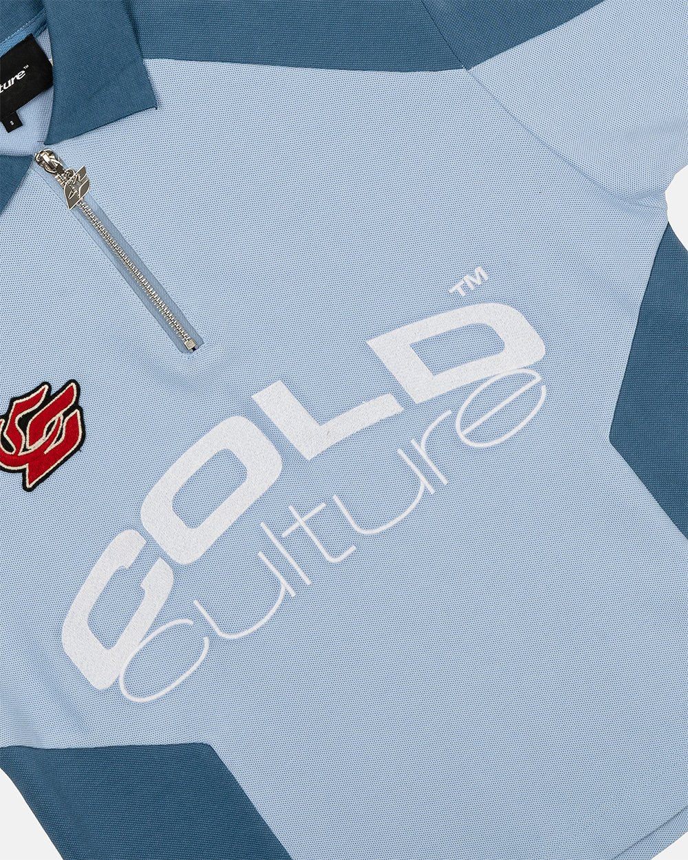 BIKER POLO LIGHT BLUE - light blue half-zip polo, detail close-up - Cold Culture