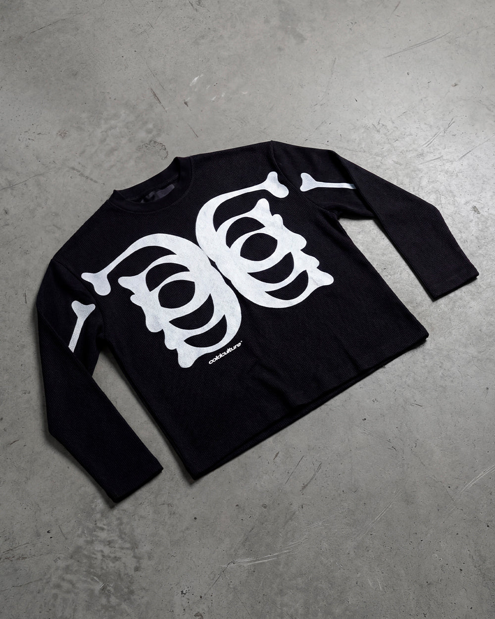 BONEY LONGSLEEVE BLACK - black skeleton print longsleeve tee, flat lay - Cold Culture