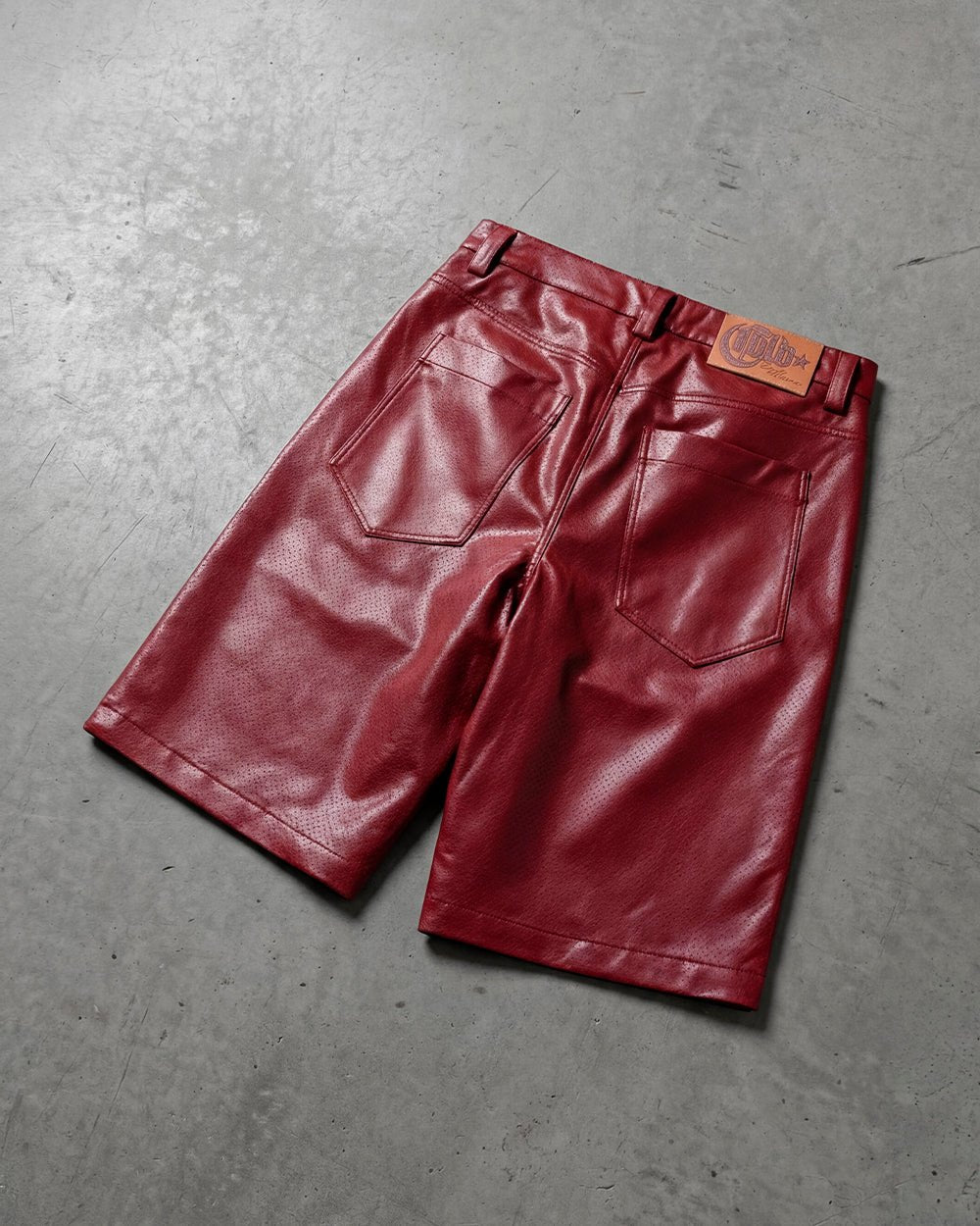 BRAVE SHORT BURGUNDY - burgundy perforated leather shorts, flat lay - Cold Culture