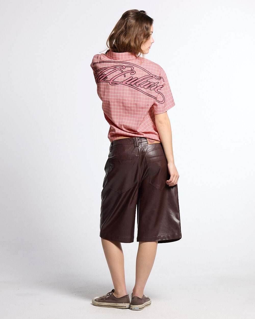 BRAVE SHORTS BROWN - brown faux leather shorts, back view on female model - Cold Culture #woman