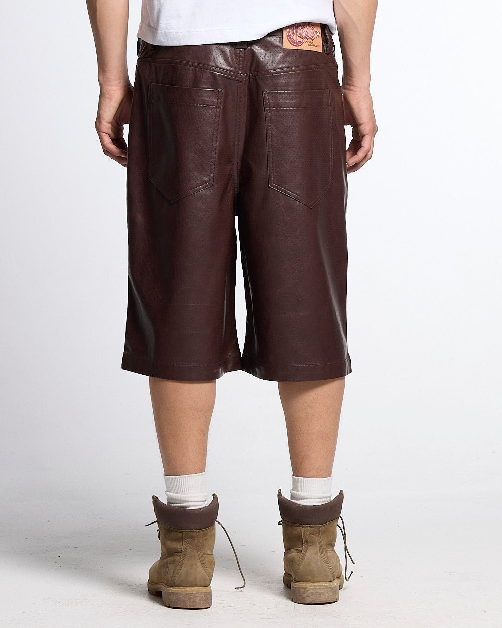 BRAVE SHORTS BROWN - brown faux leather shorts, back view on male model - Cold Culture