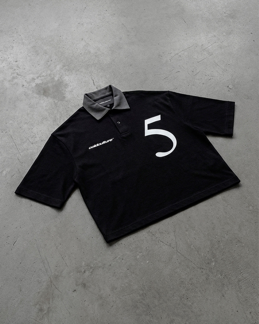 BRIGHTON POLO BLACK - black cropped polo shirt, flat lay - Cold Culture