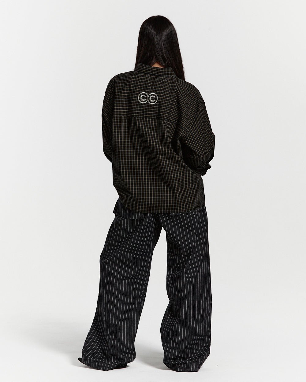 CASINO PANTS BLACK DENIM - black pinstripe denim pants, back view on female model - Cold Culture #woman