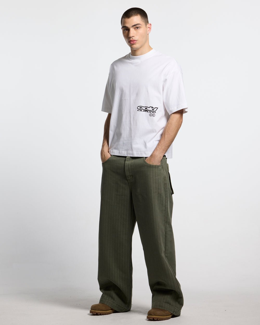 CASINO PANTS GREEN DENIM - green pinstripe denim pants, front view on male model - Cold Culture #man