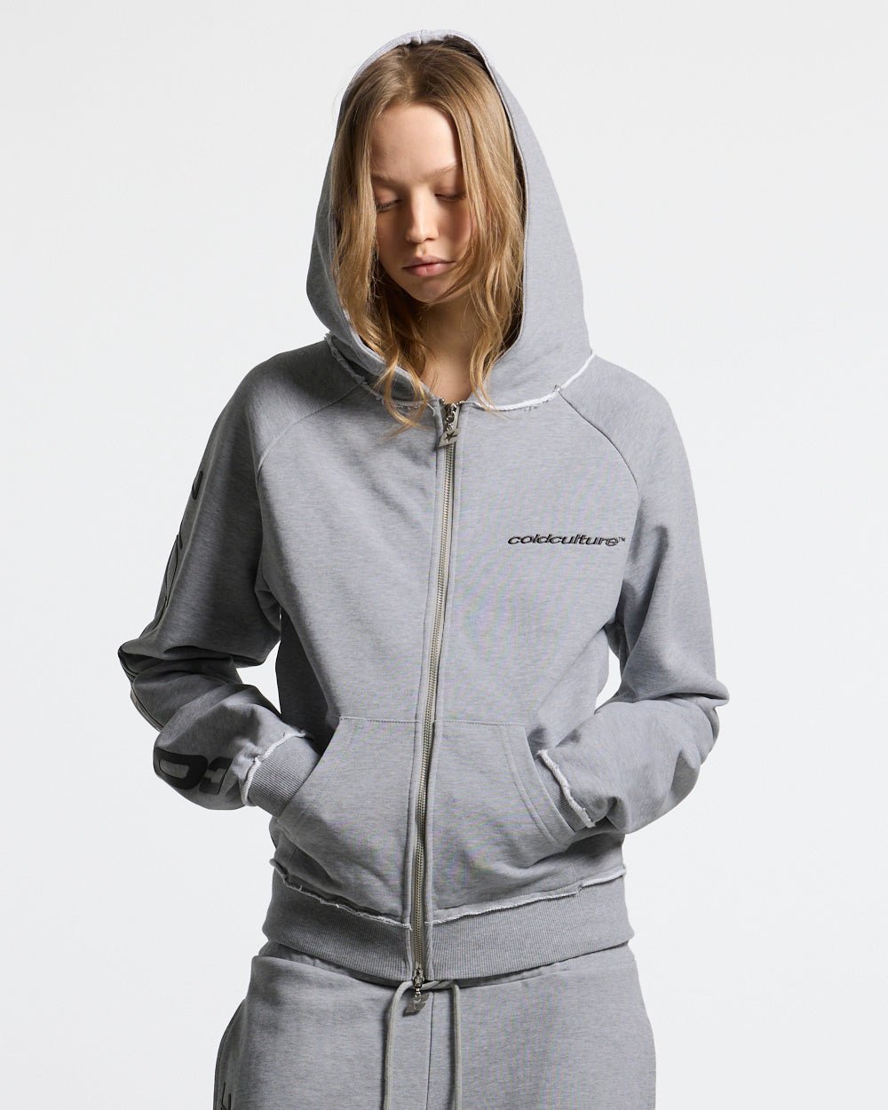 COLD SPORT ZIP HOODIE GREY - grey zip-up hoodie, front view on female model - Cold Culture #woman