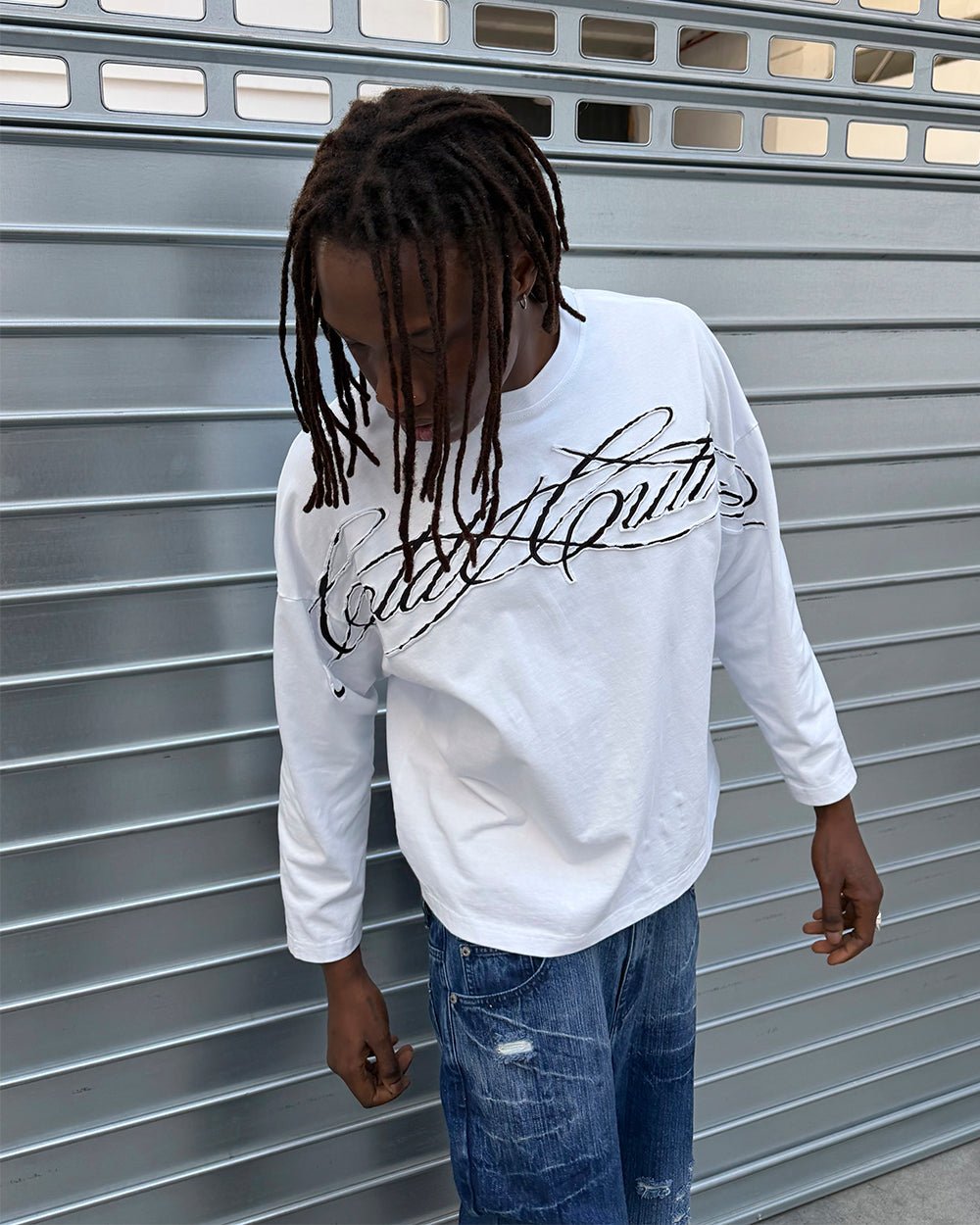 CROSSED SCRIPT LONGSLEEVE 2.0 WHITE - white script print longsleeve tee, street style shot - Cold Culture