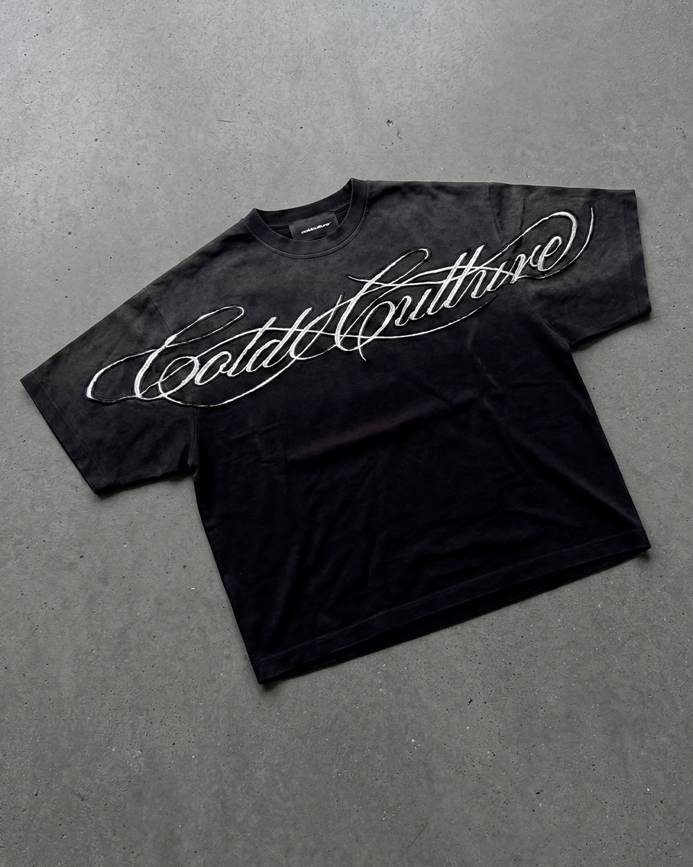 CROSSED SCRIPT TEE 2.0 BLACK - washed black script print tee, flat lay - Cold Culture