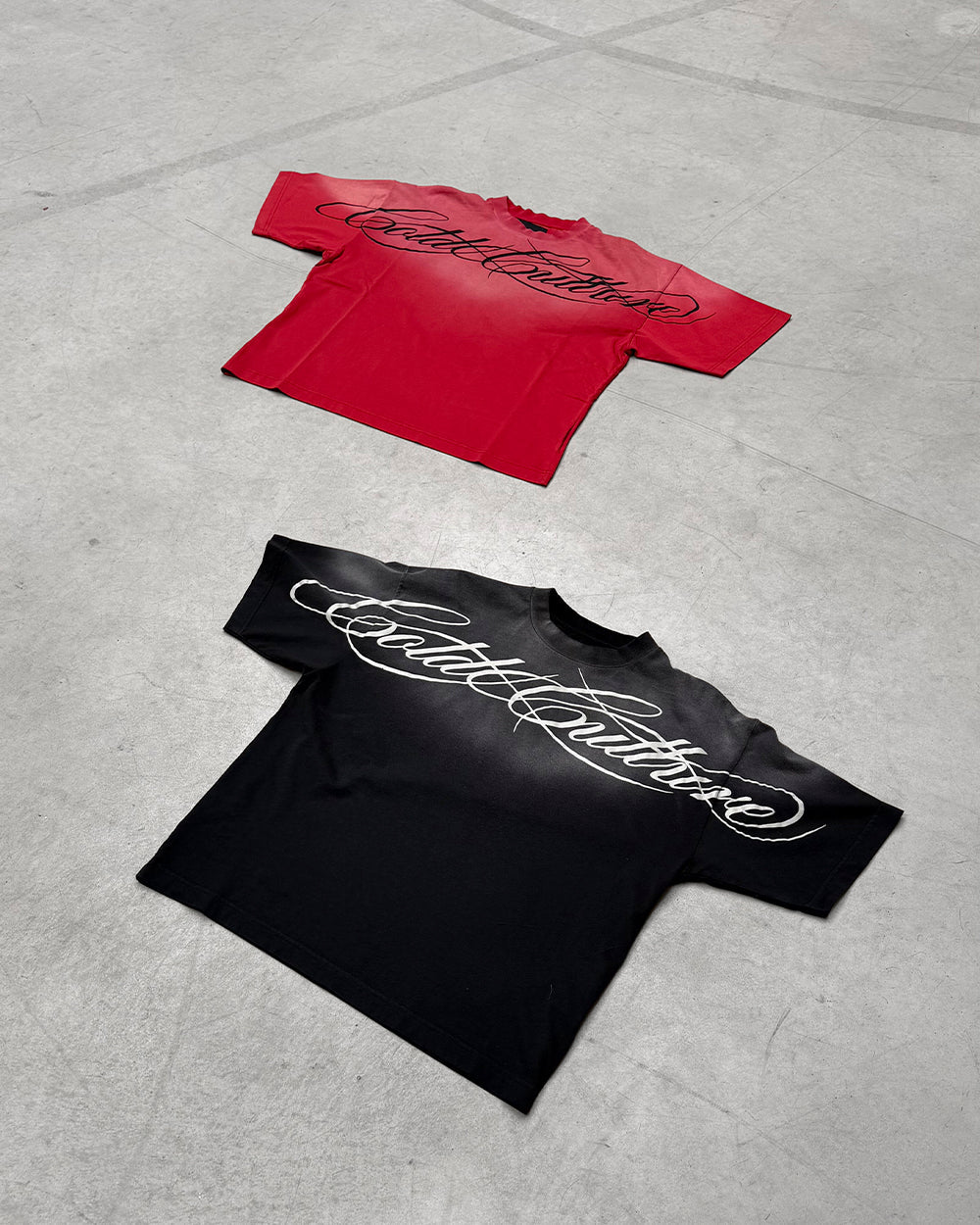 CROSSED SCRIPT TEE RED - washed red tee, flat lay with matching pieces - Cold Culture