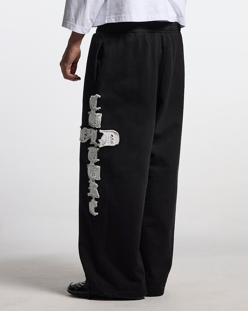 CROSSED SWEATPANTS BLACK - black baggy sweatpants, back view on male model - Cold Culture