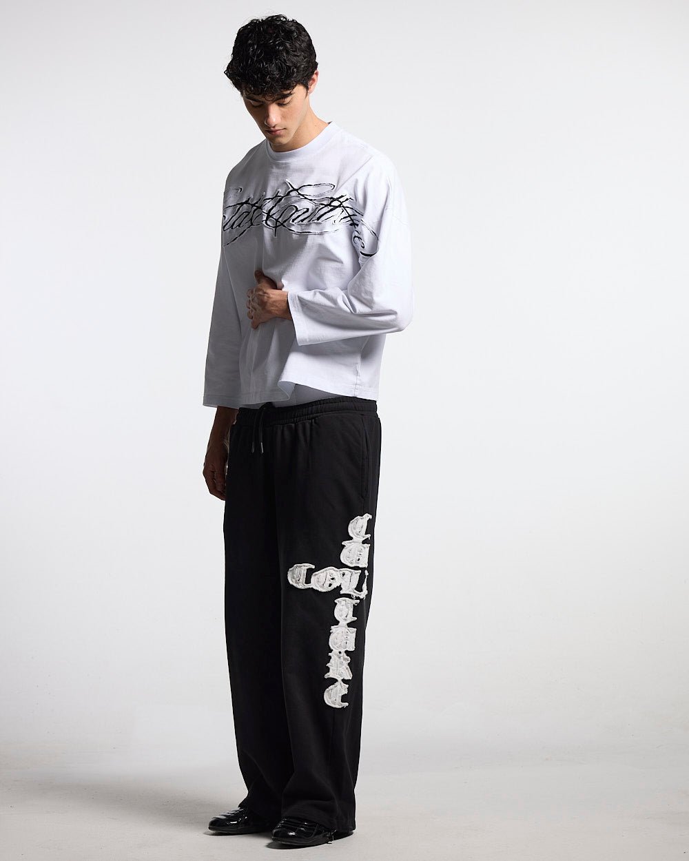 CROSSED SWEATPANTS BLACK - black baggy sweatpants, front view on male model - Cold Culture #man