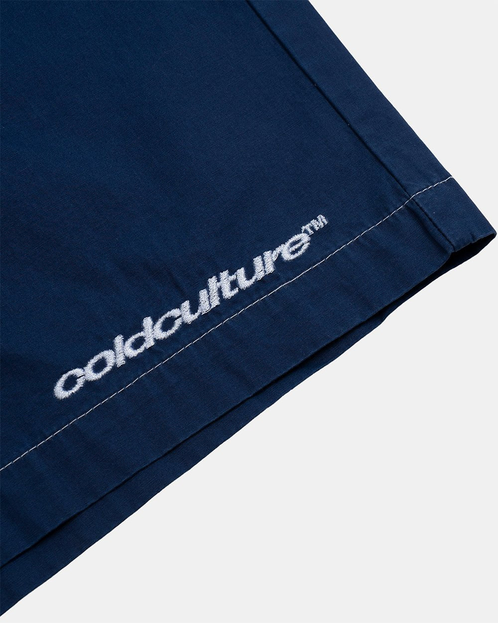 CROSSED SWIMSHORTS BLUE - navy gothic print swim shorts, detail close-up - Cold Culture